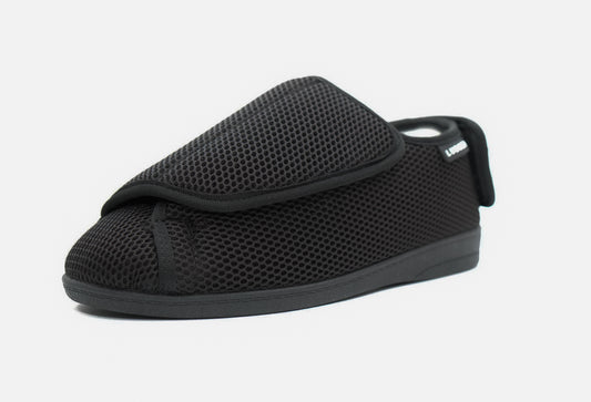 A black women's diabetic shoe with a velcro strap and a mesh upper.