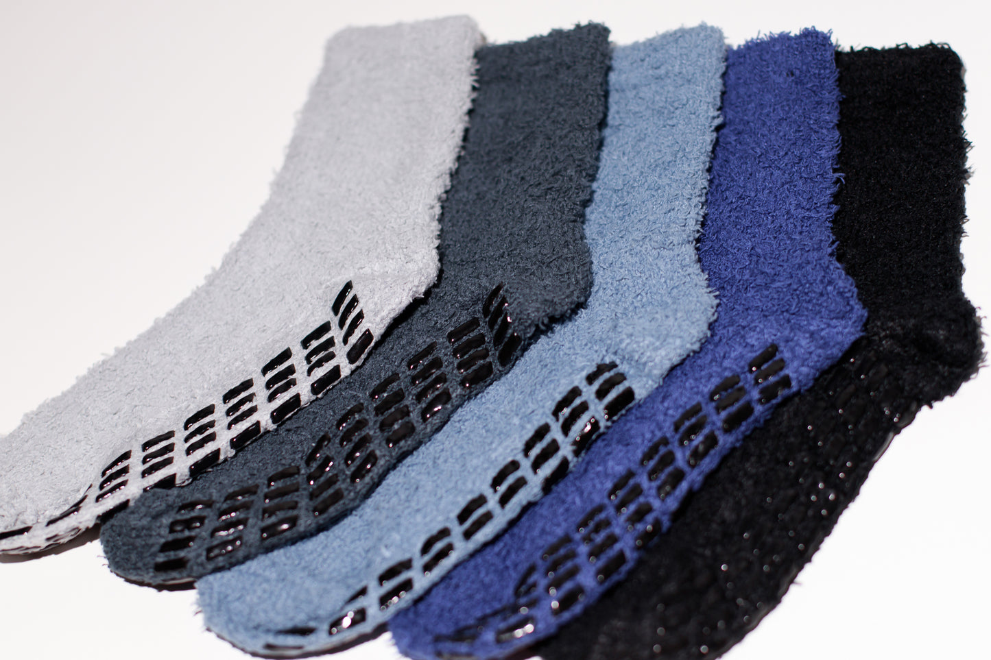 non-slip hospital socks in various colors, featuring a textured grip on the sole.