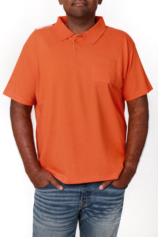 A man wearing an orange t-shirt with half sleeves and an open back design, standing with his hands in pockets.