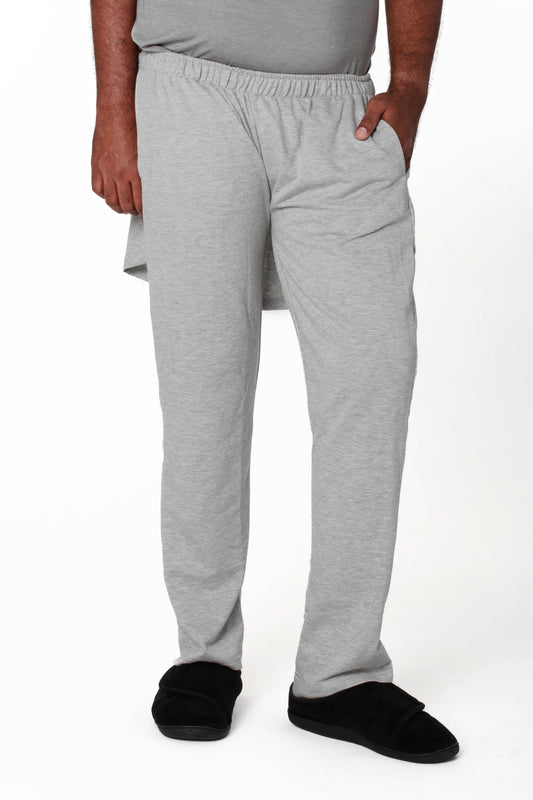 A model wearing unisex gray fleece adaptive pants with an open back design.
